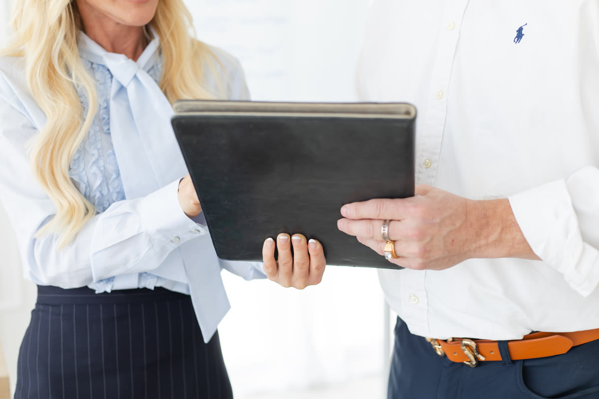 Two colleagues reviewing a portfolio together
